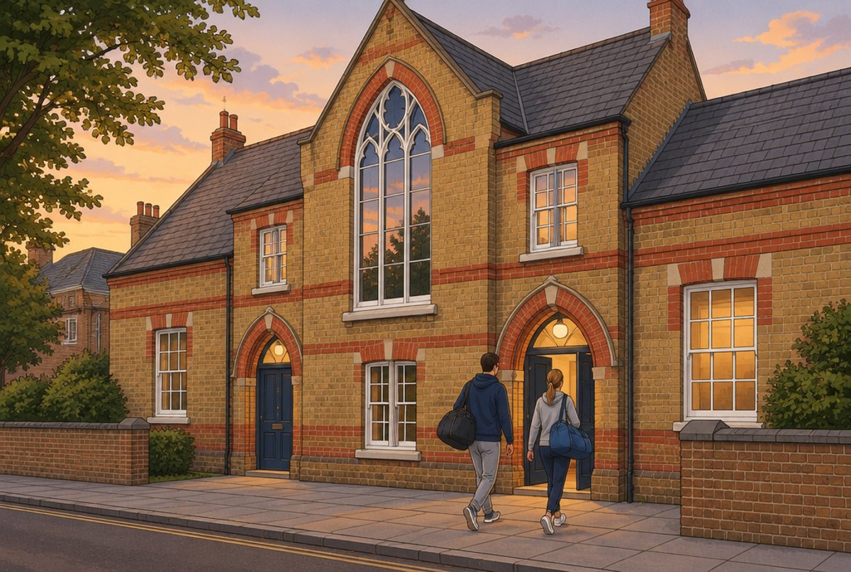 A Victorian brick building with arched doors and a pointed window on a quiet London street.